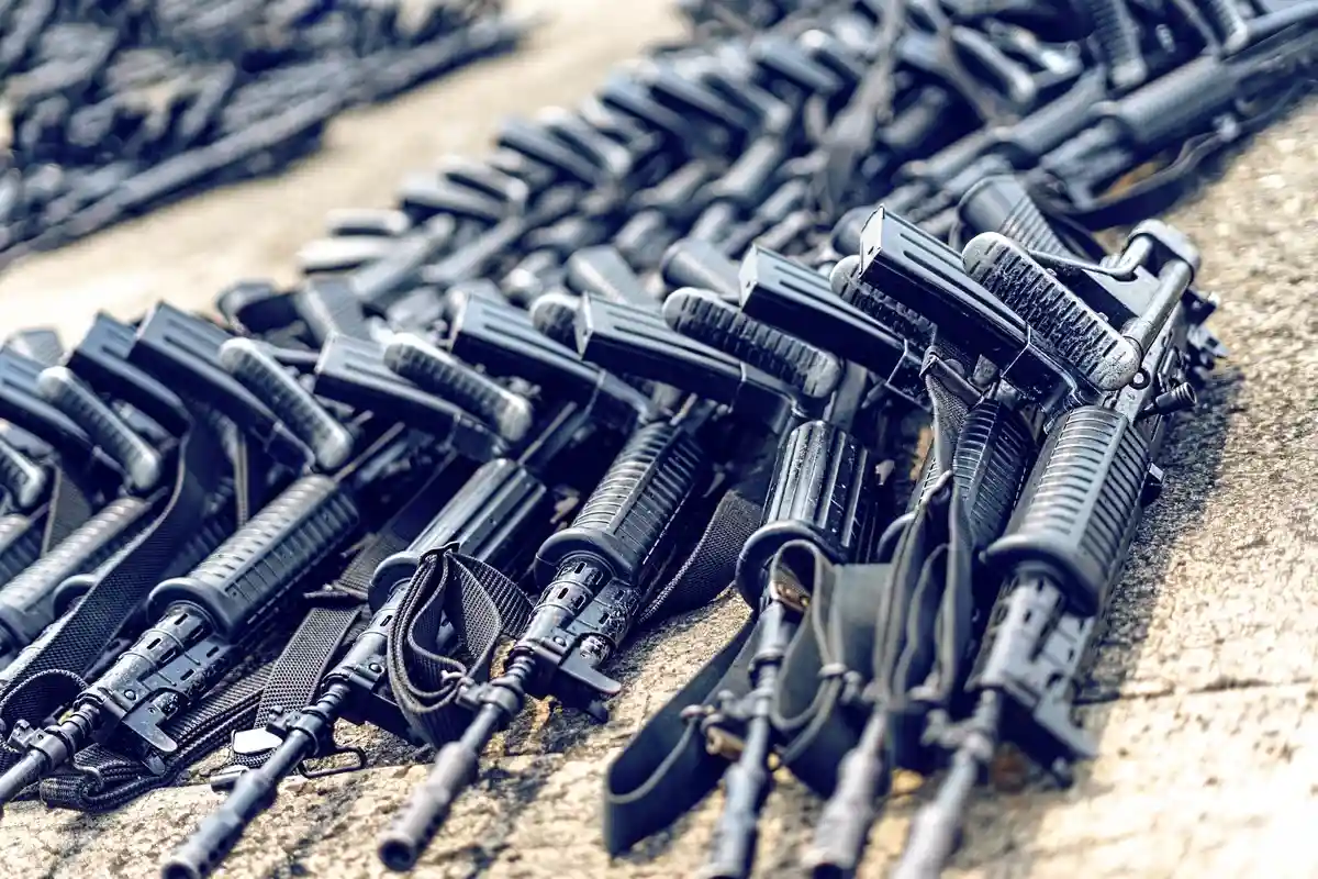 Множество черных штурмовых винтовок на земле Фото: acarapi/Shutterstock.com