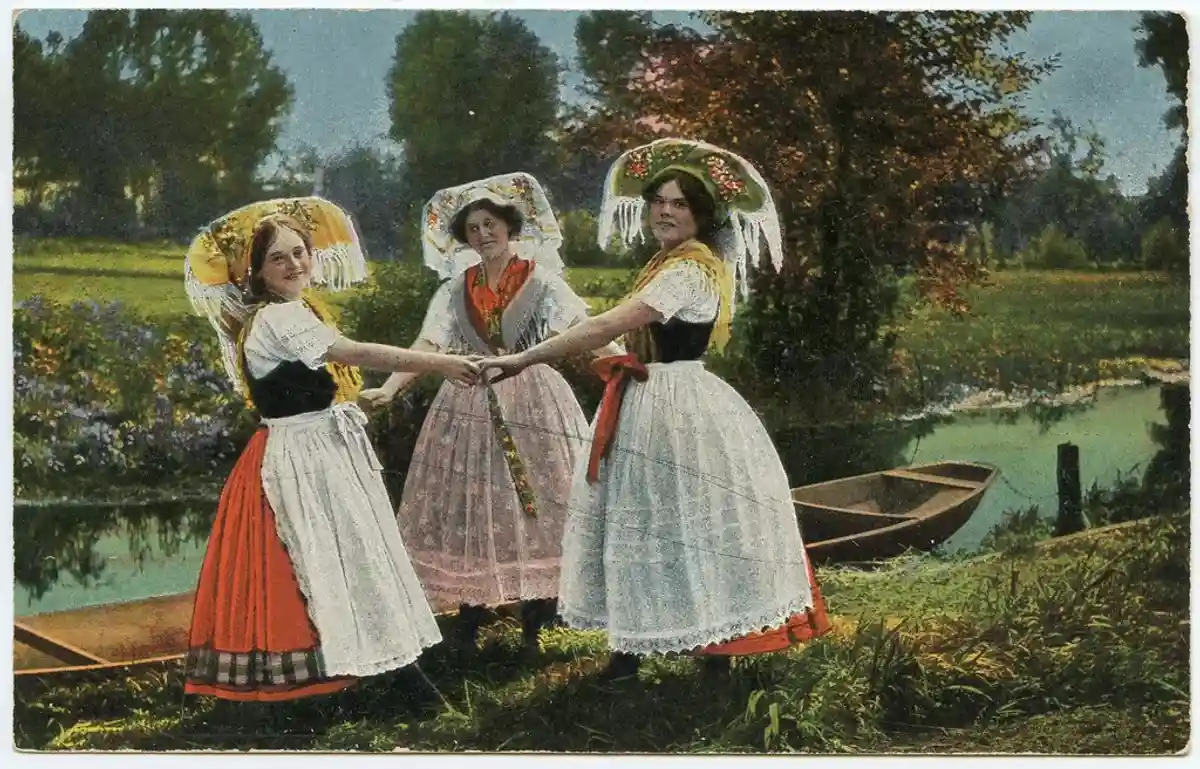 Старинная открытка «В Шпреевальде», на которой изображены девушки в вышитых костюмах. Автор: Кай Хайнрих.