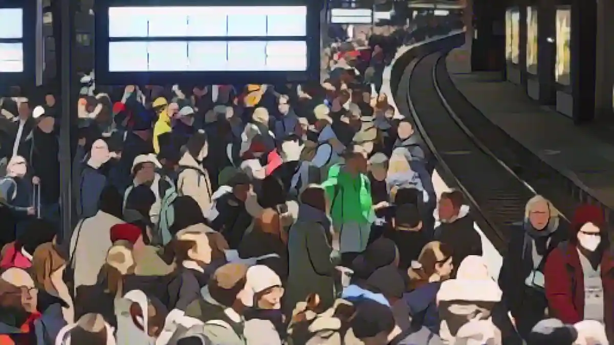 Многочисленные путешественники ждут своего поезда на переполненной платформе главного вокзала.:Многочисленные путешественники ждут своего поезда на переполненной платформе главного вокзала. Фото