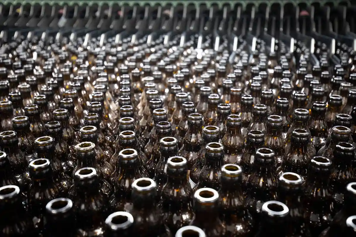 Пивоварня:Пустые пивные бутылки в бутылкомоечной машине на заводе по производству пива.