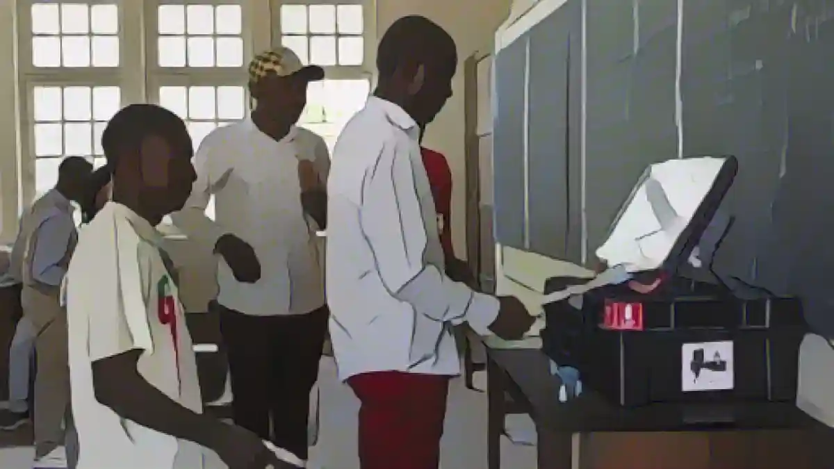 Работники избирательных участков в Лубумбаши проверяют машину для голосования.:Работники избирательных участков в Лубумбаши проверяют машину для голосования