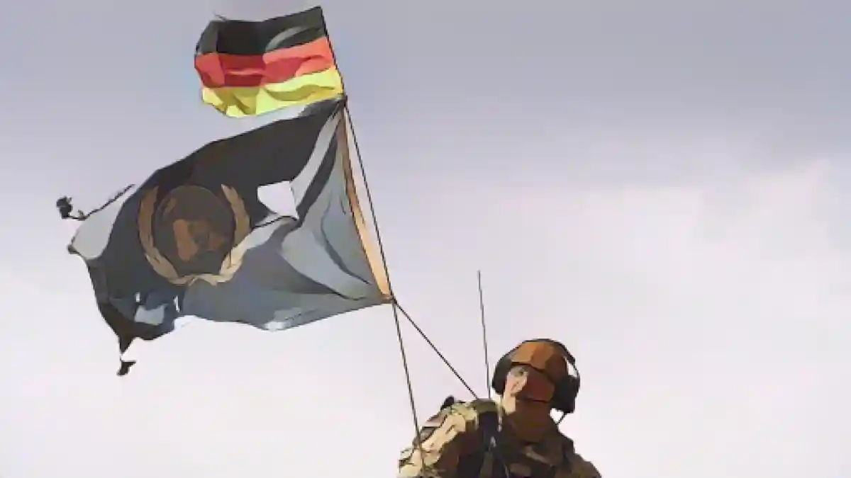 Солдат бундесвера с флагом Германии и ООН во время службы в Мале:Солдат бундесвера с флагом Германии и ООН во время службы в Мали