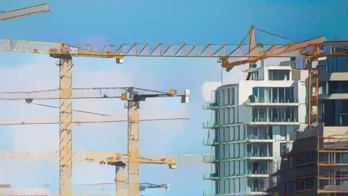 Строительные краны стоят на строительной площадке в центре города.:Строительные краны стоят на строительной площадке в центре города. Фото