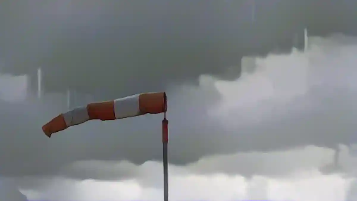 В штормовую погоду ветроуказатель развевается на ветру.:Ветроуказатель в штормовую погоду. Фото