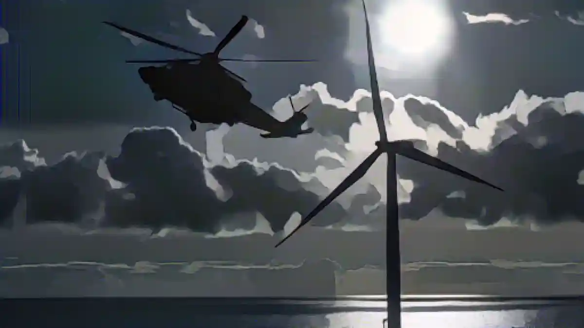 Вертолет пролетает над морской ветряной электростанцией.:Вертолет пролетает над оффшорной ветряной электростанцией. Фото