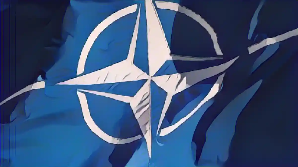 Флаг НАТО развевается на ветру.:Флаг НАТО развевается на ветру. Фото
